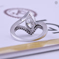 Curved wedding ring displayed to show the unique bypass wrap detail around the band