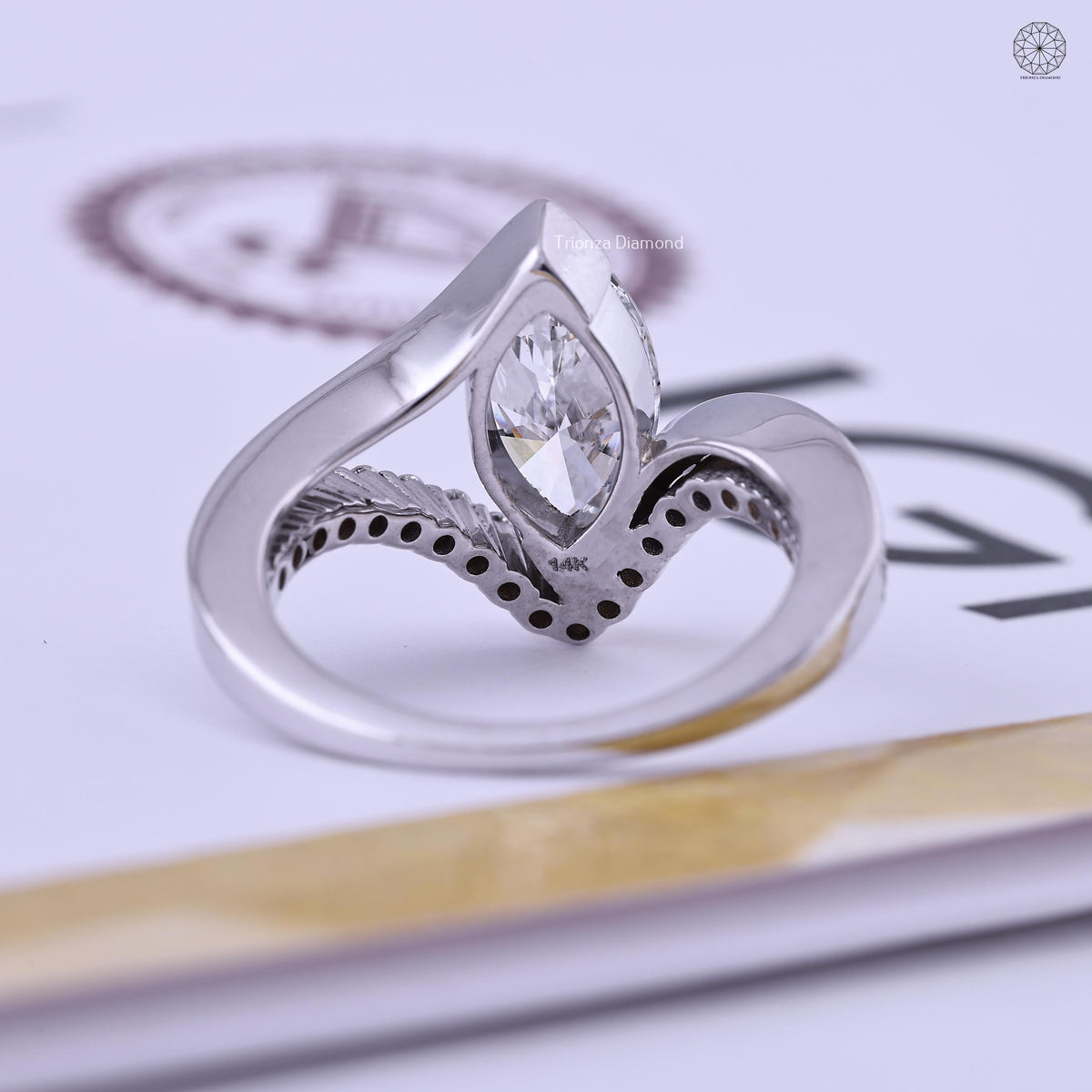 Curved wedding ring displayed to show the unique bypass wrap detail around the band