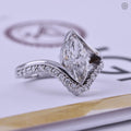 Close-up of the 2 carat marquise diamond set in a half bezel bypass solitaire ring