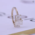 Side view of the three stone ring displaying the prong set emerald cut diamonds