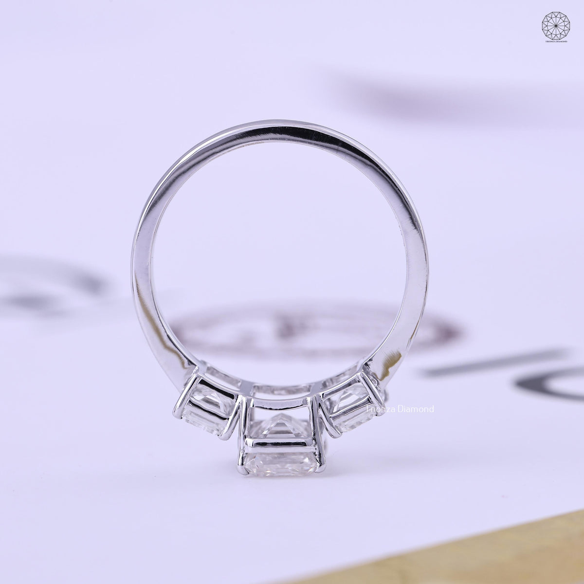 Woman wearing the three stone emerald cut engagement ring for an elegant everyday look
